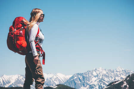 Woman backpacker traveling in mountains Travel Lifestyle concept adventure active vacations outdoor hiking sportの写真素材