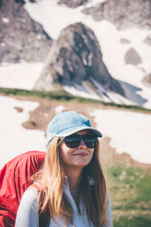 Happy Woman Traveler with backpack hiking in mountains landscape Travel Lifestyle concept adventure extreme vacations outdoor into the wildの写真素材
