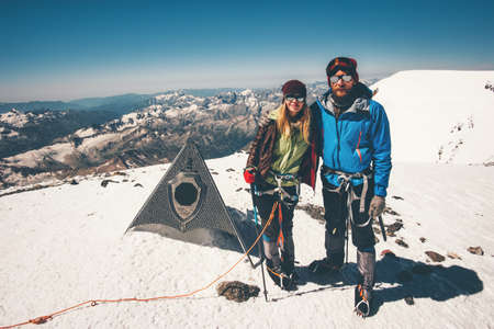 Couple Man and Woman climbing reached Elbrus mountain east summit Travel Lifestyle success concept adventure active vacations together outdoor mountaineering sport happy emotions の写真素材
