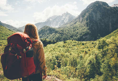 Traveler Woman hiking in mountains with backpack Travel Lifestyle concept adventure summer vacations outdoor mountaineering sport active leisure into the wildの写真素材