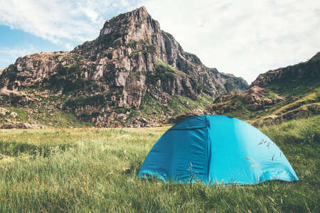 Tent camping and rocky Mountains Landscape Travel Lifestyle concept Summer adventure vacations outdoorの写真素材