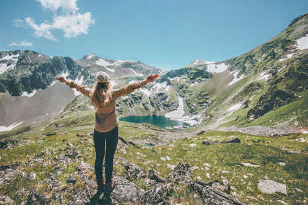Woman hands raised enjoying landscape mountains and lake Travel Lifestyle adventure concept summer vacations outdoor exploring wild natureの写真素材