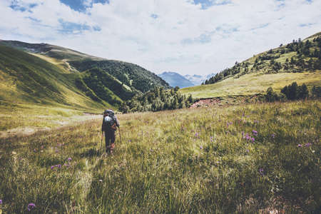 Hiking vacations at wild nature Traveler Man with backpack in mountains Travel Lifestyle concept adventure summer vacations outdoorの写真素材