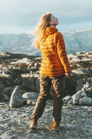 Blonde young Woman outdoor in mountains relaxing Travel healthy Lifestyle concept harmony with natureの写真素材