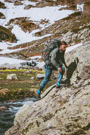 Man tourist with backpack hiking travel in mountains Lifestyle survival concept adventure outdoor active vacations mountaineering sport wild natureの写真素材