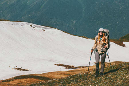 Happy smiling woman hiking with backpack adventure Travel healthy Lifestyle concept outdoor active summer vacations in mountainsの写真素材
