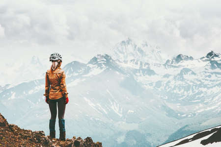 Woman hiking in snowy mountains Travel Lifestyle adventure concept active summer vacations outdoor climbing sport success and harmony emotionsの写真素材