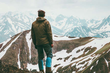 Climber Man reached mountain summit Travel Lifestyle concept traveler enjoying  landscape outdoor activity vacations wild natureの写真素材