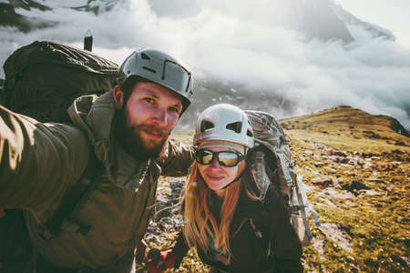 Couple travel selfie man and woman hiking in mountains love and adventure Lifestyle wanderlust conceptの写真素材