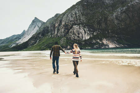 Romantic Couple in love walking holding hands on beach sea man and woman together traveling Lifestyle concept vacations outdoorの写真素材