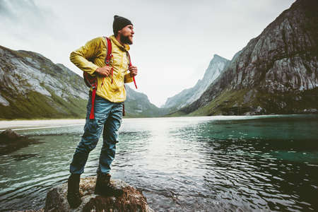 Man backpacker walking on Horseid beach in Norway Travel lifestyle wanderlust concept adventure outdoor summer vacations wild nature の写真素材
