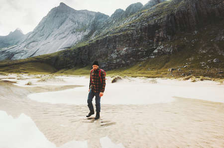 Tourist Man walking alone in mountains Travel lifestyle wanderlust concept adventure outdoor summer vacations wild nature の写真素材