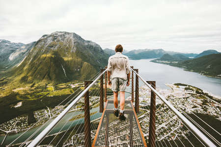 Man traveler alone sightseeing aerial mountains landscape Traveling Lifestyle adventure vacations Rampestreken viewpoint in Norwayの写真素材