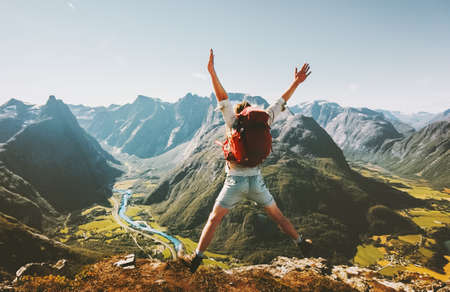 Happy Man traveler jumping with backpack.の写真素材