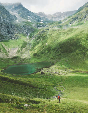 Man traveler mountaineering Travel adventure active lifestyle concept lake and mountains on background summer vacations outdoor の写真素材