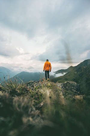 Man hiking in mountains adventure  traveling solitude lifestyle concept active weekend journey vacations wilderness moody natureの写真素材
