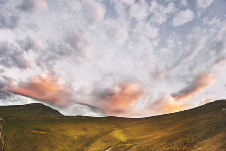 Sunset mountains and clouds sky landscape travel nature background awesome tranquil evening scenery の写真素材