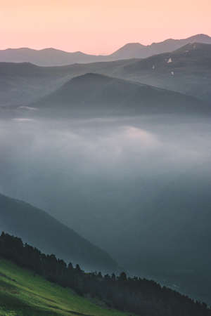 Forest mountains sunset foggy Landscape Travel tranquil aerial view wilderness nature evening sceneryの写真素材