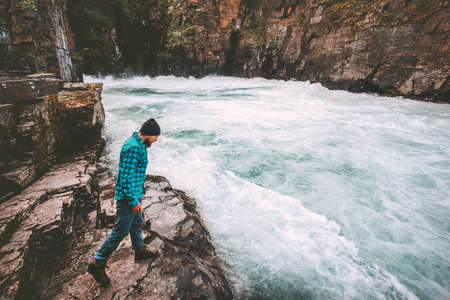 Man traveling in river canyon adventure lifestyle extreme vacations outdoor wilderness natureの写真素材