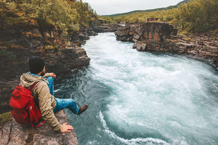 Man traveling relaxing alone with river canyon view adventure lifestyle hiking adventure vacations outdoor exploring Swedenの写真素材