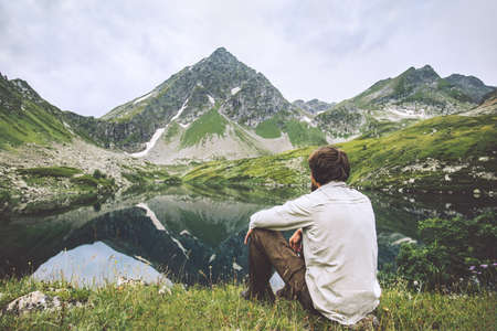 Man enjoying landscape traveling alone adventure vacations solitude lifestyle outdoor silence lake and mountains reflection landscapeの写真素材