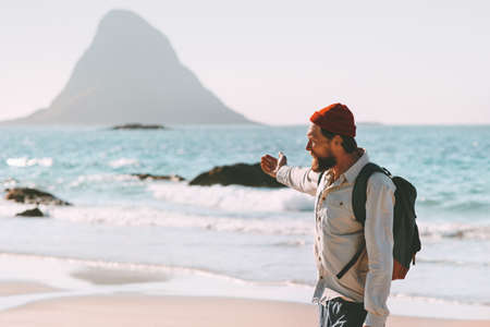 Man traveler relaxing on ocean beach enjoying landscape summer traveling lifestyle adventure vacations in Norway active trip exploring outdoor の写真素材