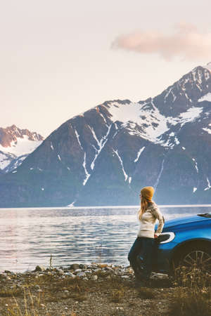 Woman solo traveling by rental car road trip in Norway Travel Lifestyle concept adventure weekend getaway vacations outdoor mountains viewの写真素材