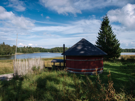 Scandinavian sauna in front of a lake in idyllic sceneryの写真素材