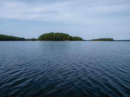 Scenery of the finnish lakes in summer surrounded by deep green forestsの写真素材