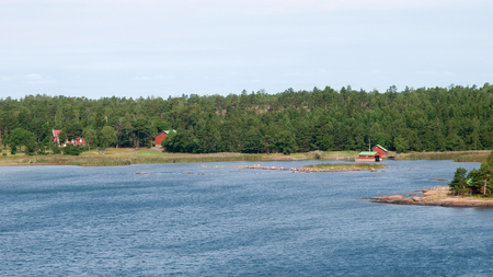 Swedish red houses along the shore of the baltic seaの写真素材