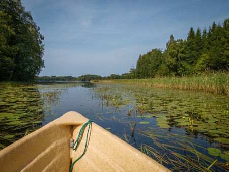 Idyllic waterways connecting the lakes of Finland between lush green forestsの写真素材