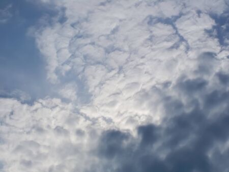 Dark clouds in a clear summer skyの写真素材