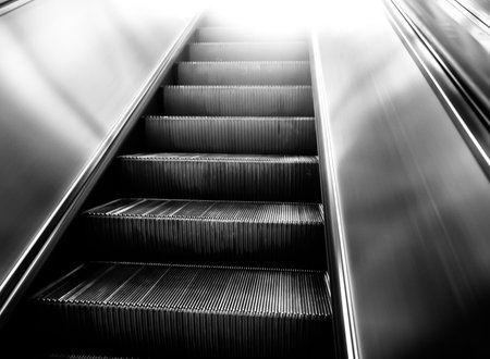 Old escalator stairway inside modern office building.の写真素材