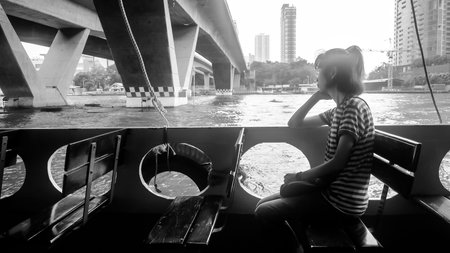 Women looking out of the ship. Women sit vacant.の写真素材