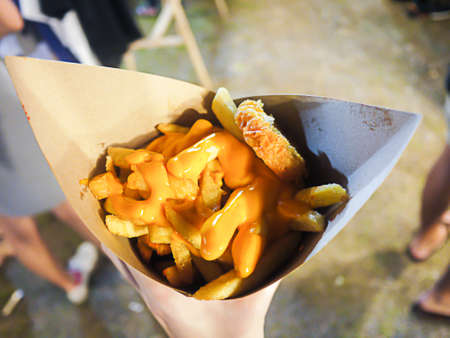 French fries topped with cheese in kraft blank paper fry box, Food street Thailand - soft focusの写真素材