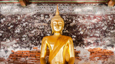 Smiley buddha statue has an ancient flower paintings and bricks are background,  Wat Suthat Thepwararam Bangkok Thailand, Historical place and Public place.の写真素材