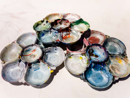 Art palettes with paint color on working table.の写真素材