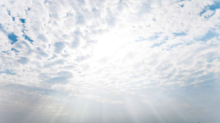 blue sky with sun and beautiful cloudsの写真素材