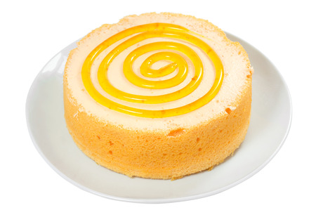 Sponge orange cake with spiral jam on plate isolated on white backgroundの写真素材