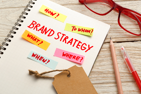 Brand marketing strategy concept with notebook and brand tag on office deskの写真素材