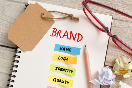Brand marketing concept with notebook, brand tag and coffee cup on work deskの写真素材