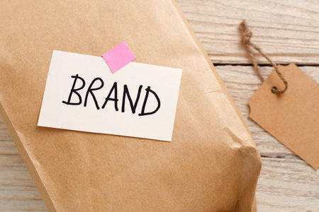 Brand marketing concept with product package, brand tag on wood desk