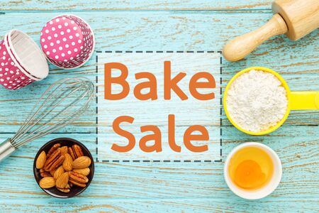 Bake sale background with baking ingredients on wood tableの写真素材