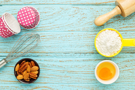 Bake background with baking ingredients on wood tableの写真素材