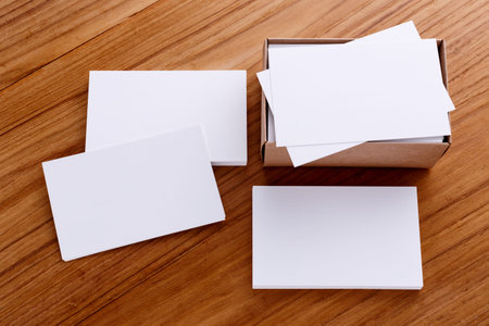 Business card blank mockup with kraft box on wood deskの写真素材