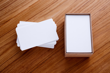 Business card blank stack mockup with kraft box on wood deskの写真素材