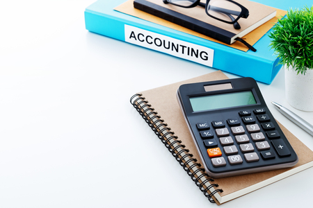 Accounting work background with calculator on notebook and spaceの写真素材
