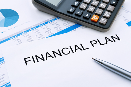 Financial plan with calculator and financial chart and penの写真素材
