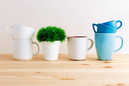Mugs and cups on wood kitchen tableの写真素材