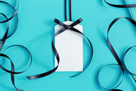 Gift tag with ribbon on blue backgroundの写真素材